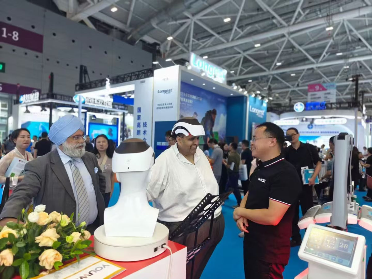 Visitors discussing YouWeMed products at a medical exhibition